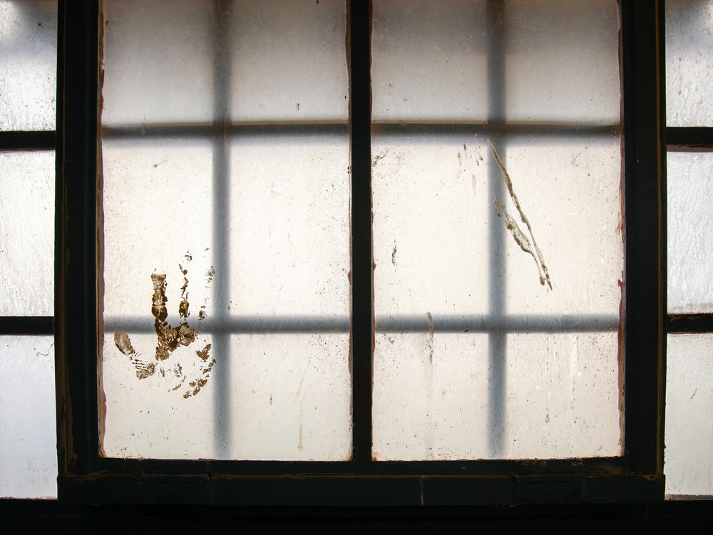 A handprint stained on the window at the Navajo Nation Detention in Shiprock, N.M., on April 13, 2021.