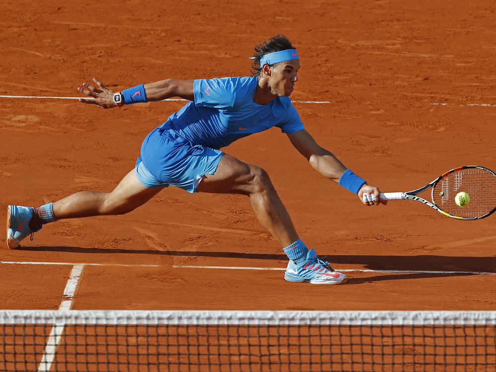 Spain's Rafael Nadal plays a shot in the fourth round match of the French Open tennis tournament against Jack Sock of the U.S. to win in four sets 6-3, 6-1, 5-7, 6-2, at the Roland Garros stadium, in Paris, France, Monday, June 1, 2015.