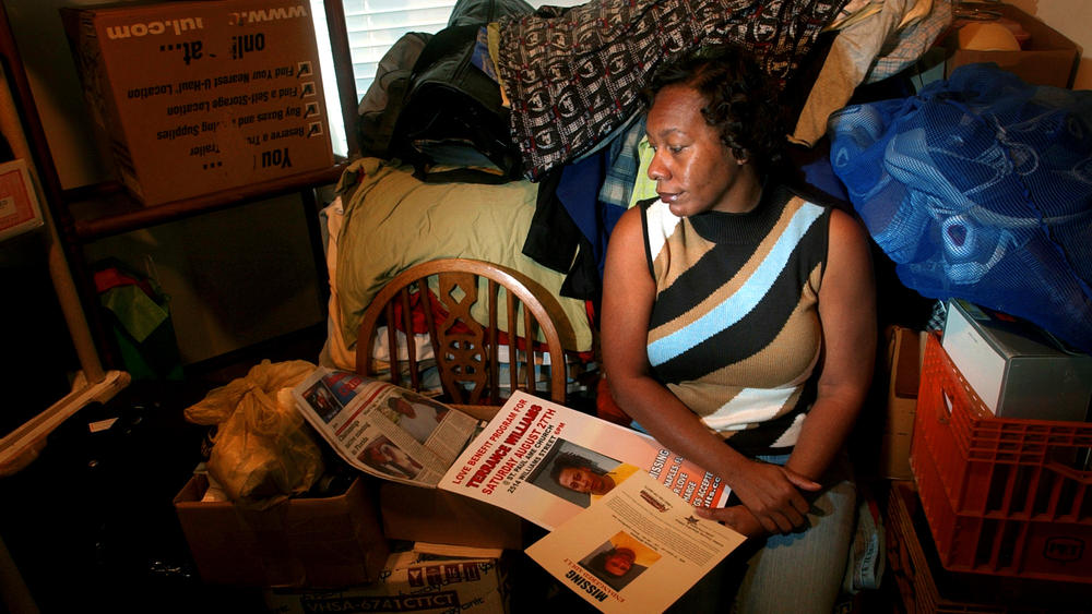 Terrance Williams' mother, Marcia Williams, sits in her apartment surrounded by some of his possessions, which fill a corner of her dining room.