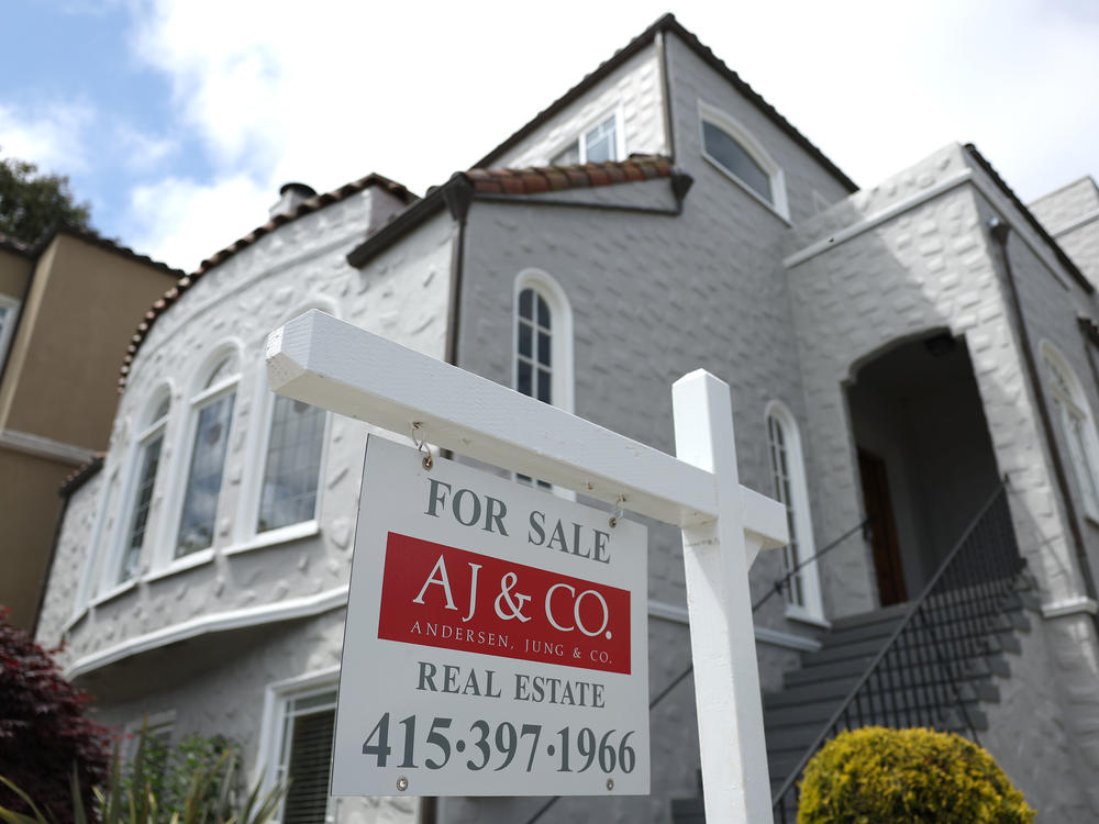 A sign is posted in front of a home for sale in San Francisco on May 11, 2023. A default could lead to a surge in already-high mortgage rates, putting homes out of reach for hundreds of thousands of would-be buyers.