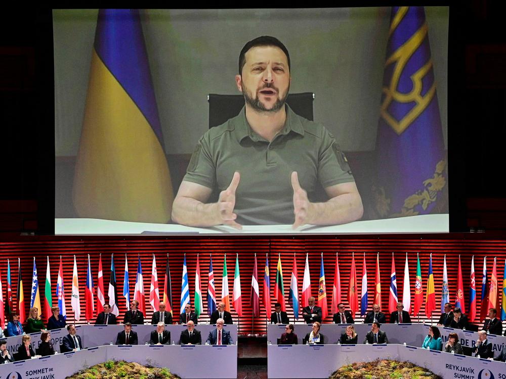 Ukraine's President Volodymyr Zelenskyy appears on screen to speak at the opening of the 4th Summit of the Heads of State and Government of the Council of Europe on May 16, 2023. Ukraine announced on Friday that Zelenskyy will travel to Japan this weekend to attend the Group of Seven leading industrial nations' summit.