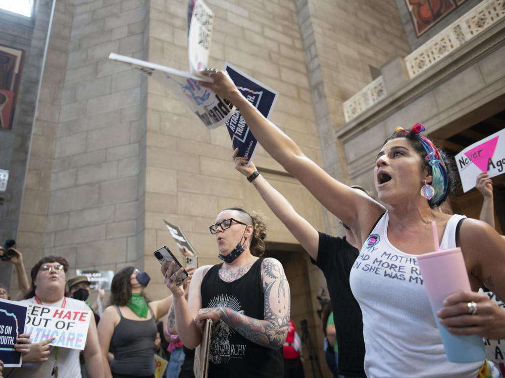 Juju Tyner of Lincoln, right, leads the singing of 