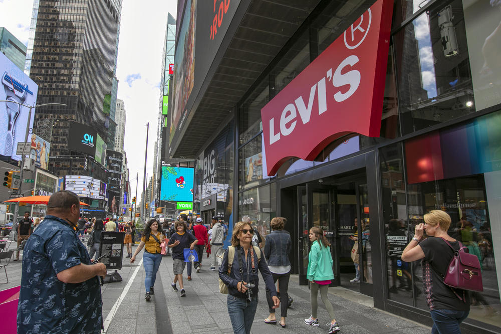 Pedestrians pass the Levi's store in in New York's Times Square. An immigrant and tailor named Jacob Davis teamed up with dry goods merchant Levi Strauss to patent the first riveted blue jeans in 1873.