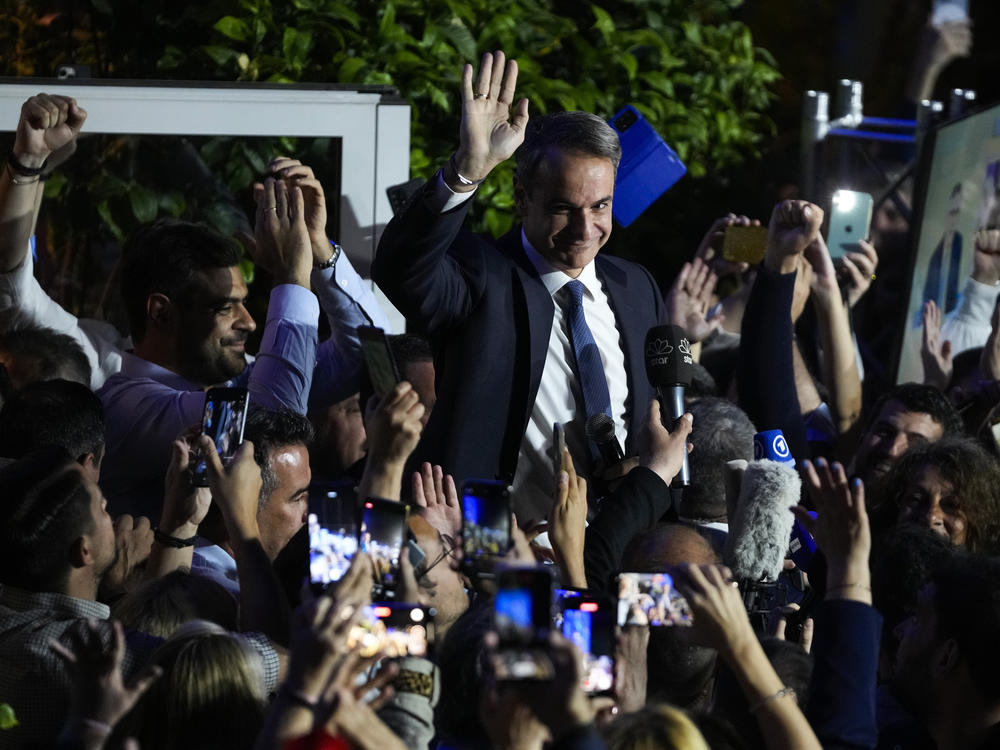 Greece's Prime Minister and leader of New Democracy Kyriakos Mitsotakis, center, addresses supporters at the headquarters of his party in Athens, Greece, Sunday, May 21, 2023.