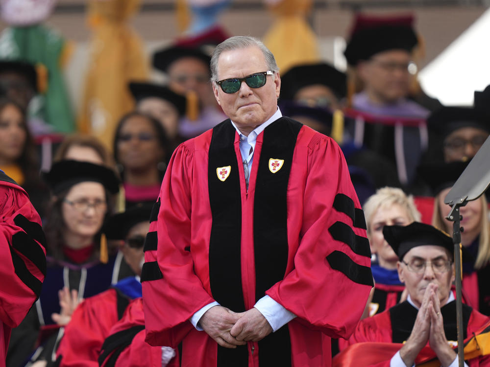 Warner Bros. Discovery CEO David Zaslav stands onstage while being introduced before delivering a commencement address at Boston University, Sunday, May 21, 2023, in Boston.