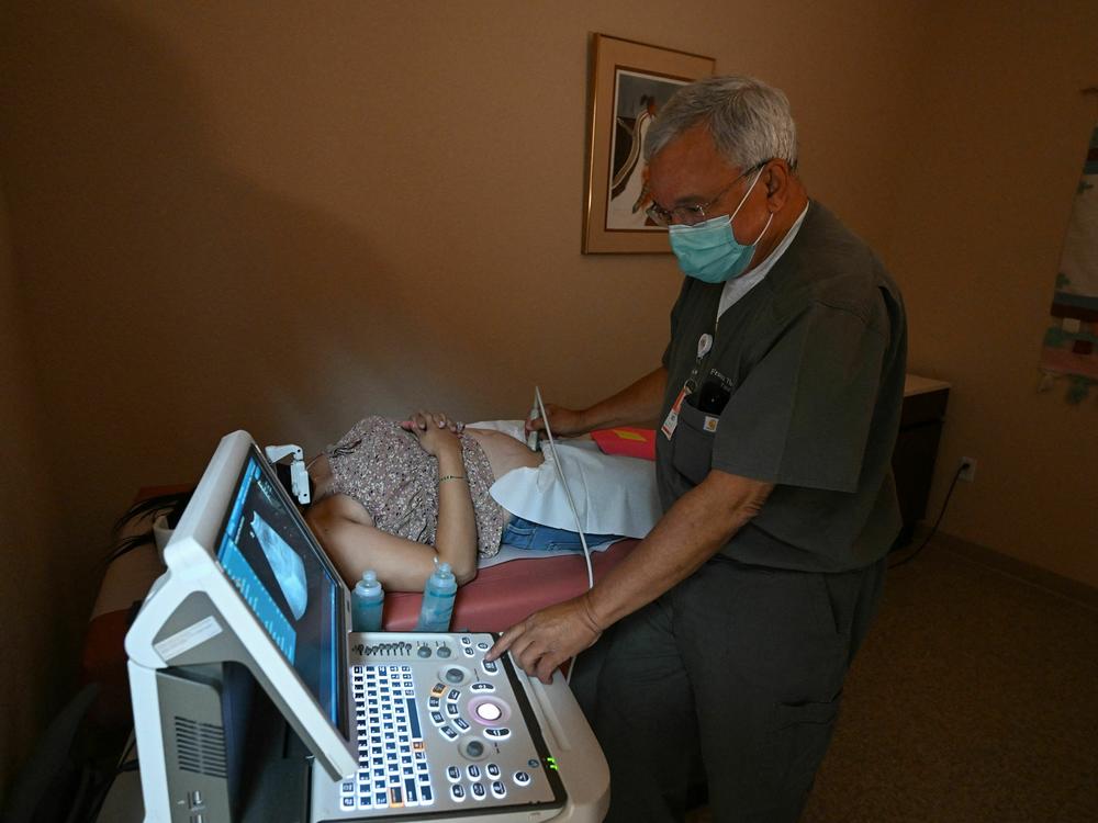 Dr. Franz Theard performs a sonogram on a patient seeking abortion services at the Women's Reproductive Clinic in Santa Teresa, New Mexico, a state that has not banned abortions.