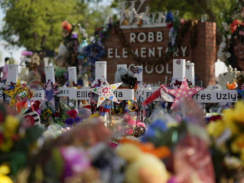 FILE - Crosses, flowers and other memorabilia form a make-shift memorial for the victims of the shootings at Robb Elementary school in Uvalde, Texas, Sunday, July 10, 2022.