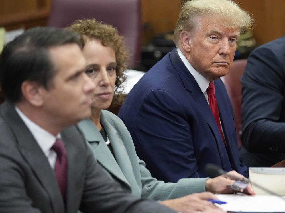 Former President Donald Trump sits at the defense table with his legal team in a Manhattan court, Tuesday, April 4, 2023, in New York.