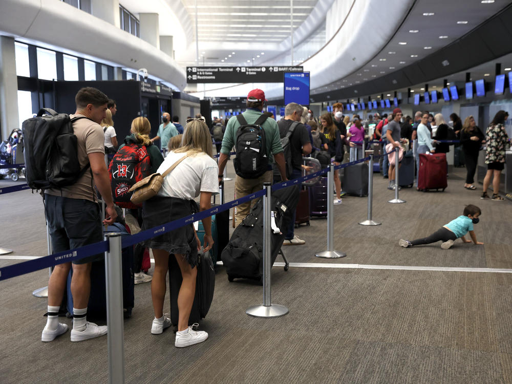 Travelers line up to check in for United Airlines flights at San Francisco International Airport on July 1, 2022 in San Francisco, Calif. This summer is expected to be a record for air travel.