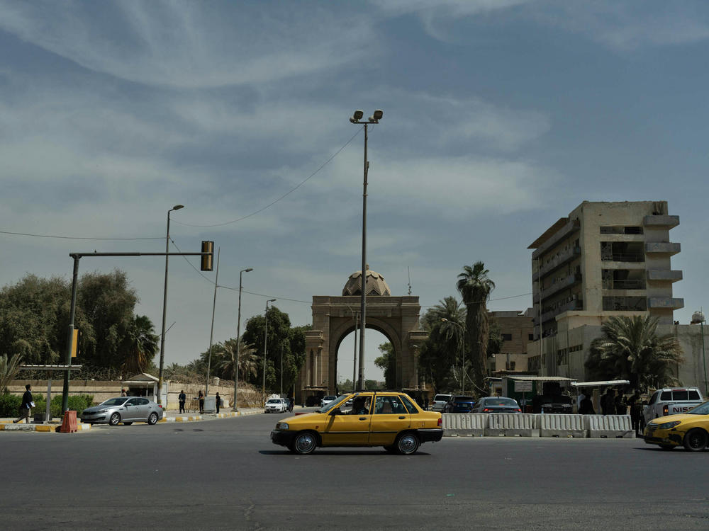A taxi travels on a wide street in central Baghdad.