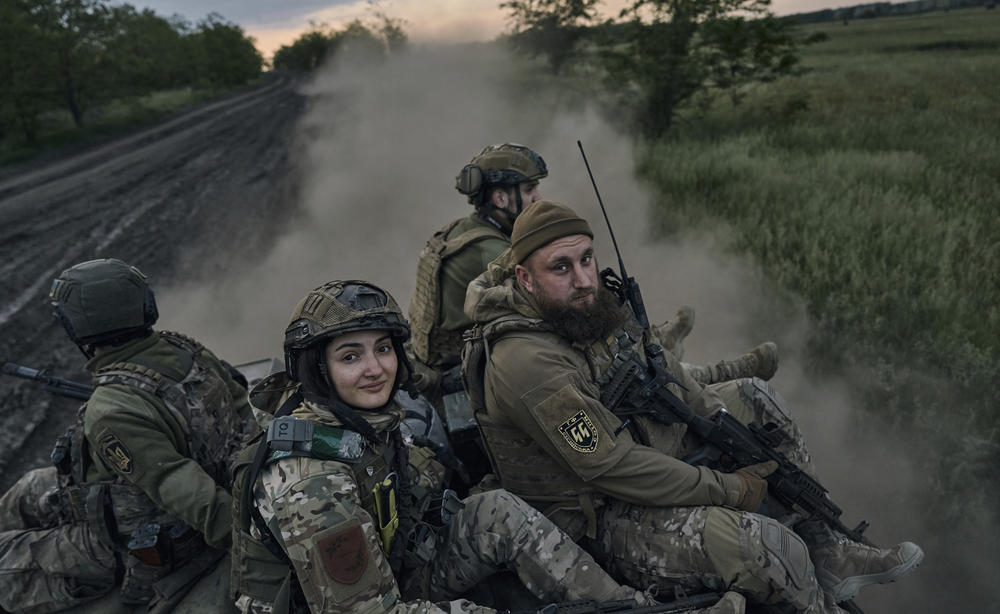 Ukrainian soldiers ride atop an armored personnel carrier in Ukraine's eastern region of Luhansk on Sunday.