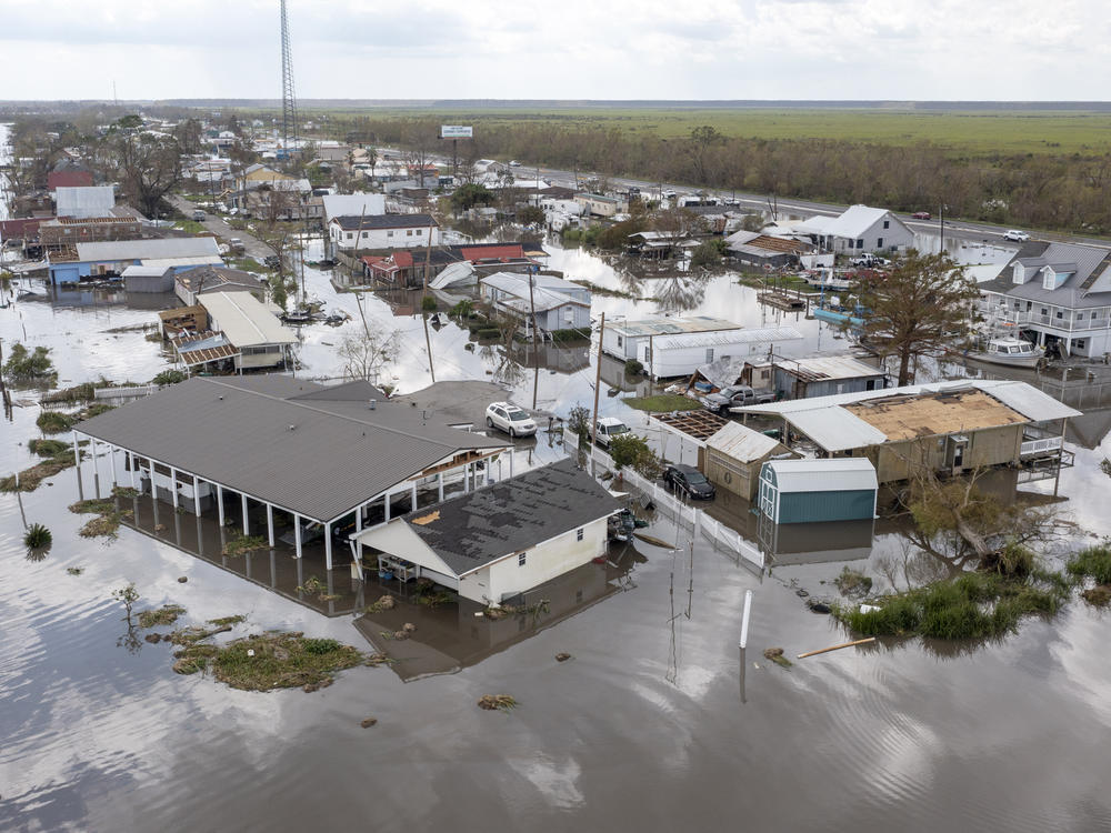 Water surrounds damaged homes in Lafourche Parish, La., after Hurricane Ida in 2021. Many people in Louisiana are still recovering from past hurricanes as this year's hurricane season gets underway. 