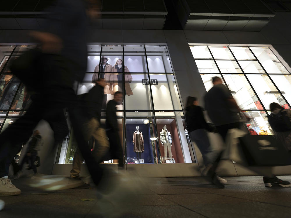 People walk past a store in Berlin on Oct. 11, 2022. The German economy shrank unexpectedly in the first three months of this year.