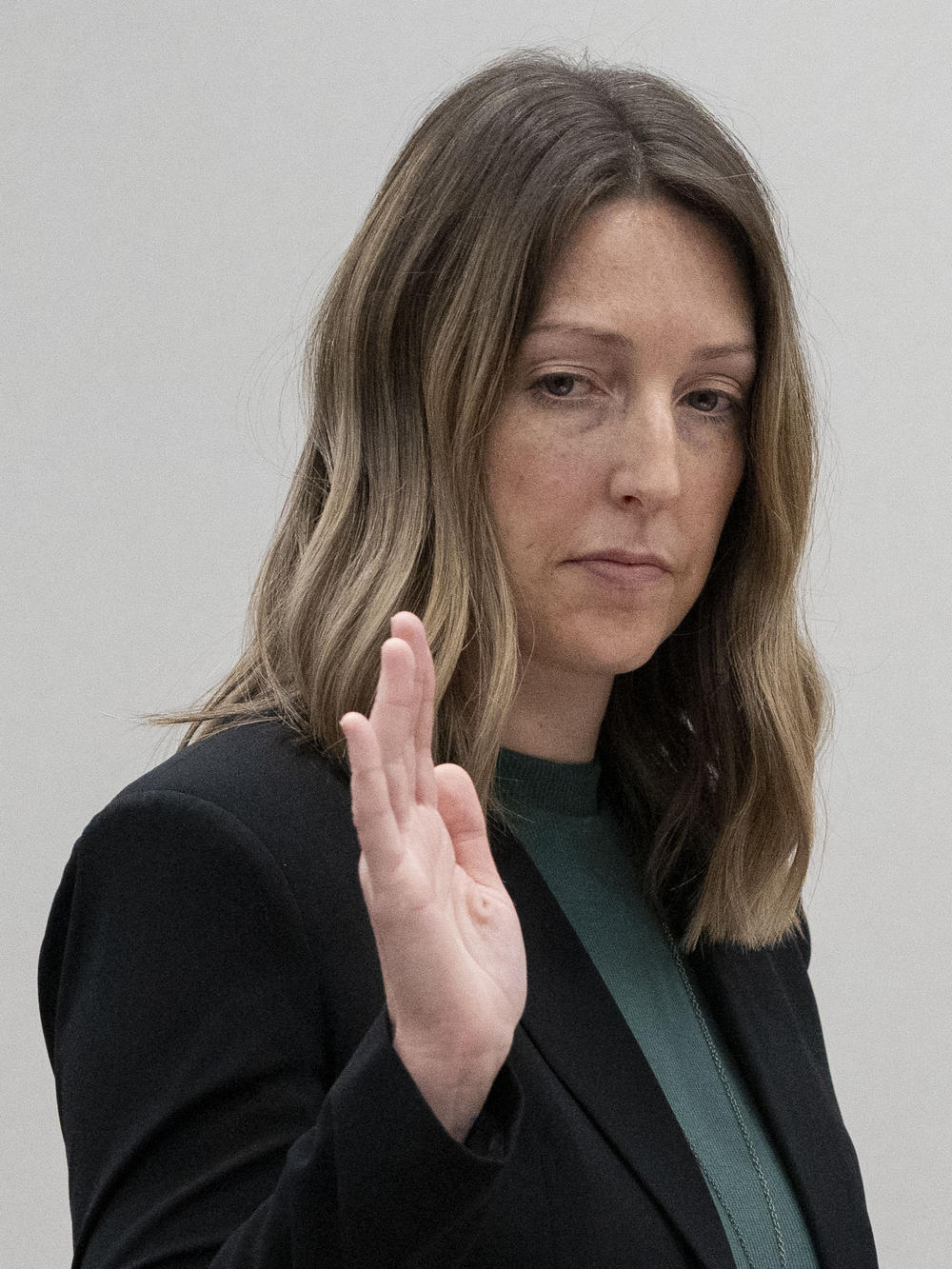 Caitlin Bernard raises her right hand as she is sworn in during Thursday's hearing in front of the state medical board in Indianapolis.