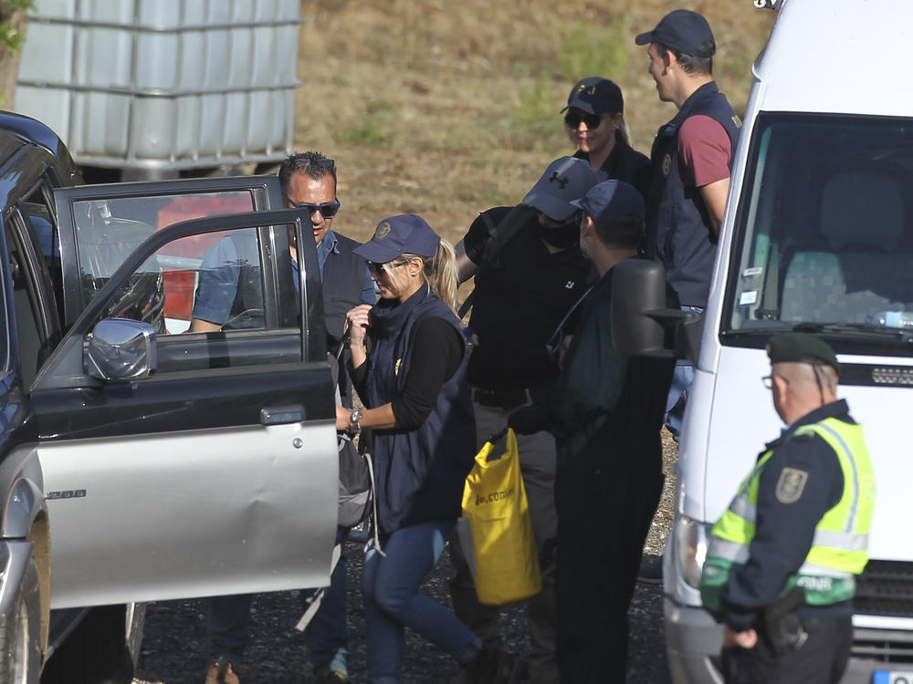 Police search teams prepare to set out from an operation tent near Barragem do Arade, Portugal, Wednesday May 24, 2023.