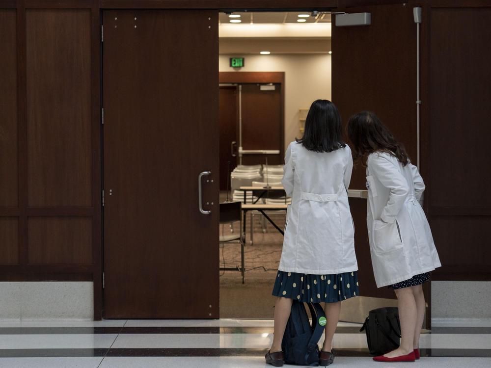 Tracey Wilkinson (left), a pediatric doctor with Indiana University School of Medicine, and Caroline E. Rouse, a maternal fetal medicine doctor with IU School of Medicine, line up outside of a conference room to support Caitlin Bernard during Thursday's hearing.