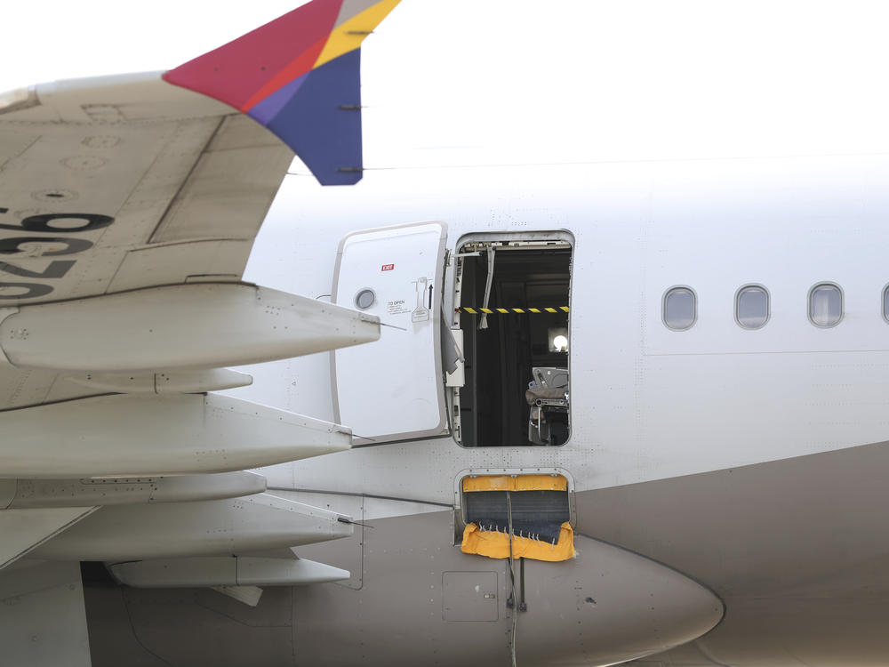 An Asiana Airlines plane is parked as one of the plane's doors suddenly opened at Daegu International Airport in Daegu, South Korea, Friday, May 26, 2023.