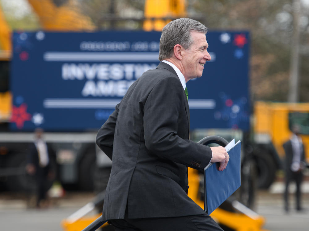 North Carolina Gov. Roy Cooper walks to the podium to speak at an event held by President Biden in Durham, N.C.