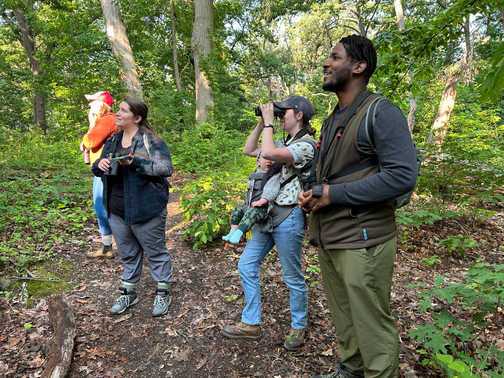 (From left) Jo Stiles, Emmie Bhagratti, Erin Connelly and Tykee James look and listen in Fort Slocum Park for birds on their spring migration.