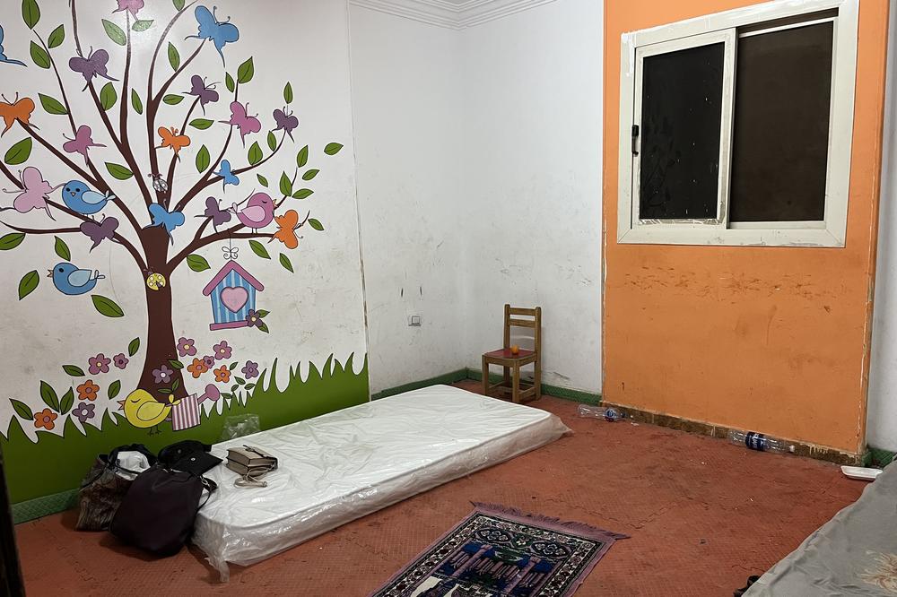 A classroom in a Sudanese school in Cairo has been transformed into a temporary shelter for migrants fleeing the conflict. A prayer mat and a woman's belongings are pictured near the mattress. May 5, 2023.