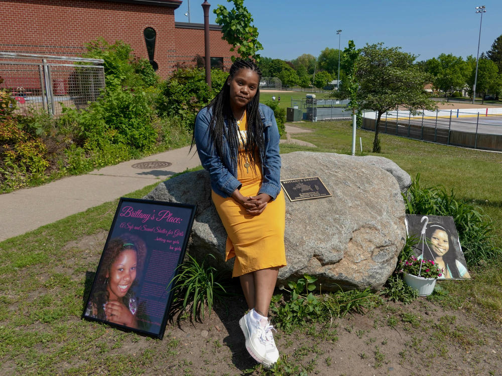 Lakeisha Lee placed flowers at the base of a monument honoring her late sister Brittany Clardy Thursday, May 26, in Saint Paul. Clardy went missing more than a decade ago and was found murdered.