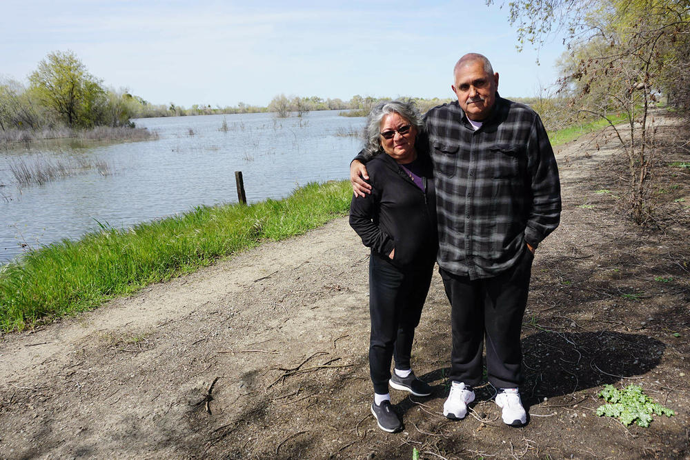 Grayson residents Lilia Lomeli-Gil and John Mataka stand next to a restored floodplain at the edge of town, providing a new open space for the community.