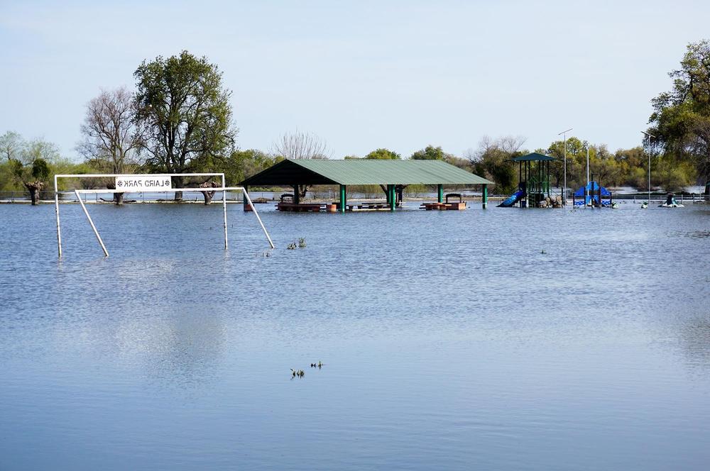 The melt of California's massive snowpack has led to chronic flooding in the Central Valley this spring, like this riverfront park near the town of Grayson.
