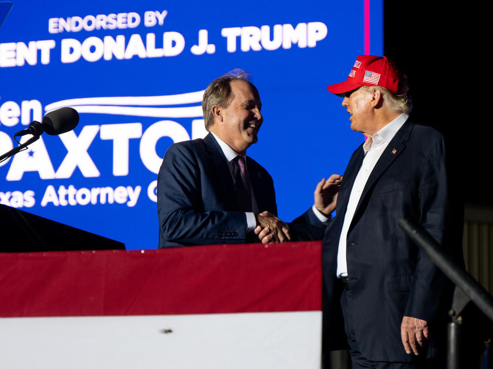 Texas Attorney General Ken Paxton greets former U.S. President Donald Trump at the 'Save America' rally on October 22, 2022 in Robstown, Texas. Paxton was impeached and suspended from office May 27, 2023.