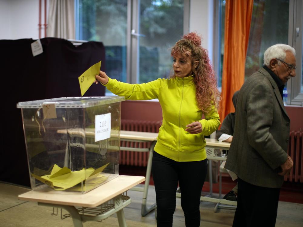 A woman votes at a polling station in Istanbul, Turkey, Sunday, May 28, 2023. Voters in Turkey return to the polls Sunday to decide whether the country's longtime leader stretches his increasingly authoritarian rule into a third decade or is unseated by a challenger who has promised to restore a more democratic society.