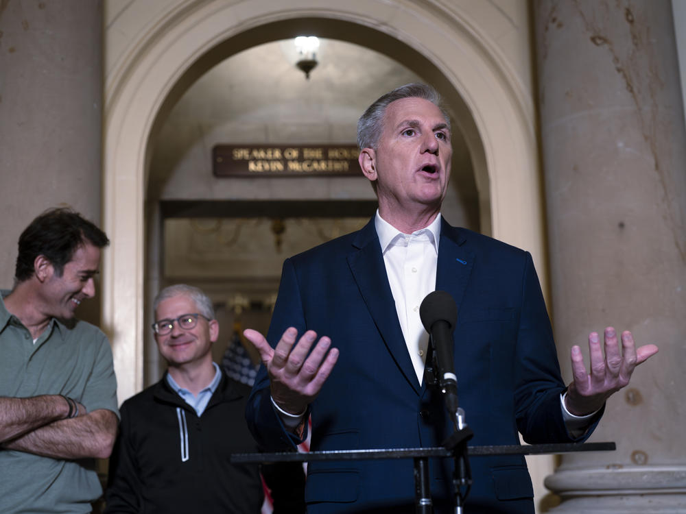 Speaker of the House Kevin McCarthy, R-Calif., is joined by his top negotiators on the debt limit, Rep. Garret Graves, R-La., left, and Rep. Patrick McHenry, R-N.C., chairman of the House Financial Services Committee, as he talks to reporters at the Capitol on Sunday.