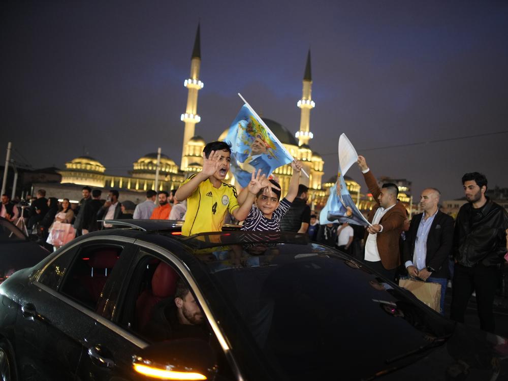 Supporters of the President Recep Tayyip Erdogan celebrate in Istanbul on Sunday.