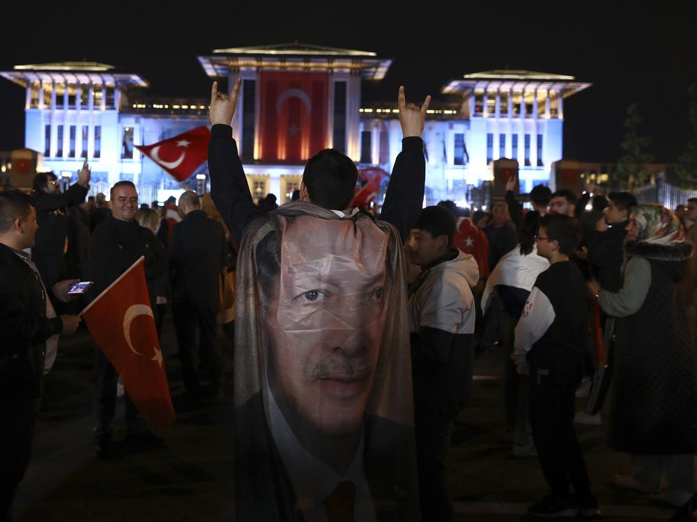 Supporters of the President Recep Tayyip Erdogan gather outside the Presidential Palace in Ankara, Turkey, on Sunday. Erdogan declared victory in his country's runoff election, extending his rule into a third decade.