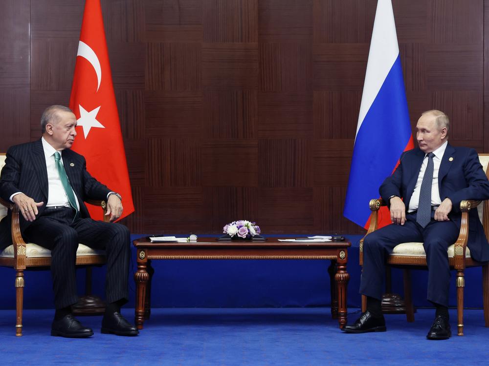 Russia's President Vladimir Putin, right, and Turkey's President Recep Tayyip Erdogan talk to each other on the sidelines of the Conference on Interaction and Confidence Building Measures in Asia  summit, in Astana, Kazakhstan, on Oct. 13, 2022.