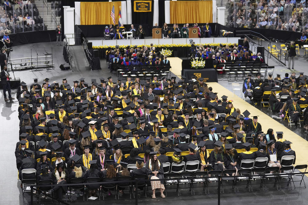 Students turn their chairs away from Wyoming Republican Liz Cheney, as she delivers the commencement address at Colorado College.
