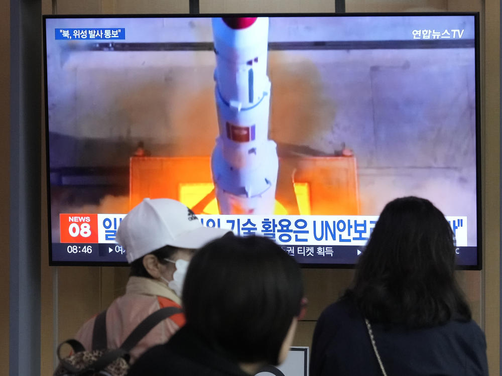 A TV screen shows a file image of North Korea's rocket launch during a news program at the Seoul Railway Station in Seoul, South Korea, on Monday.