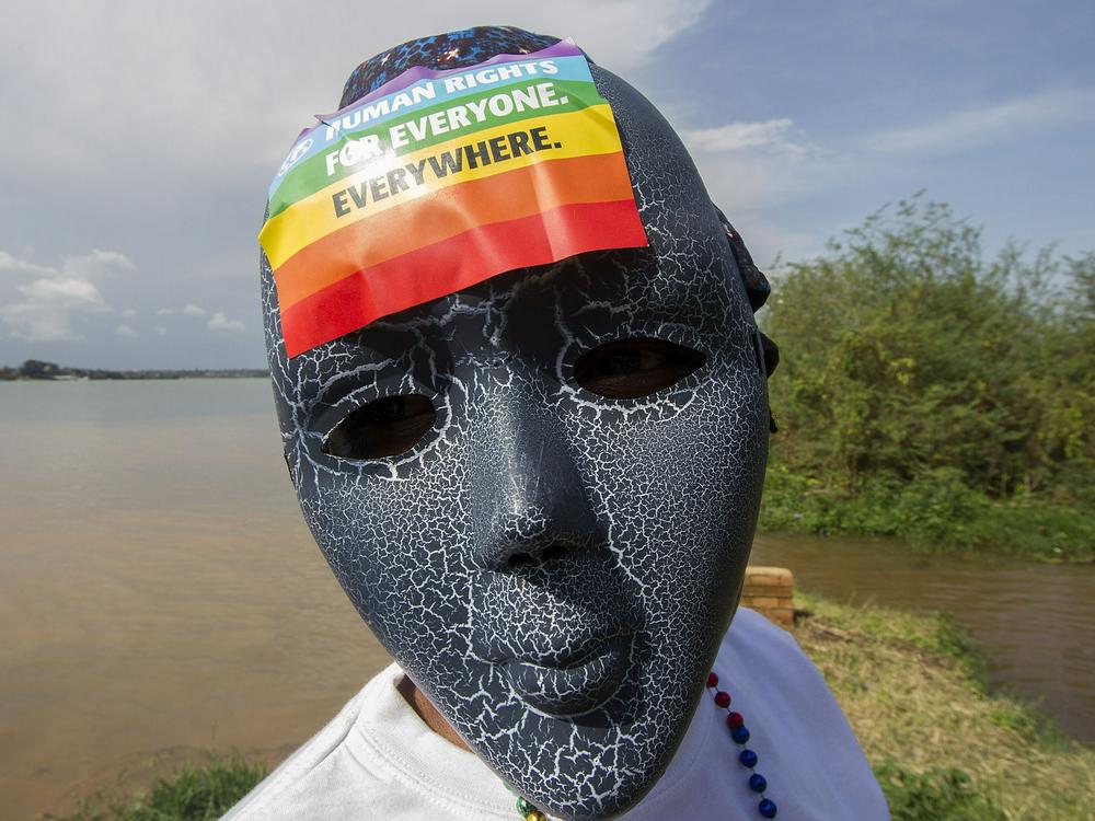 A Ugandan wearing a mask with a rainbow sticker takes part in the Gay Pride parade in 2015.