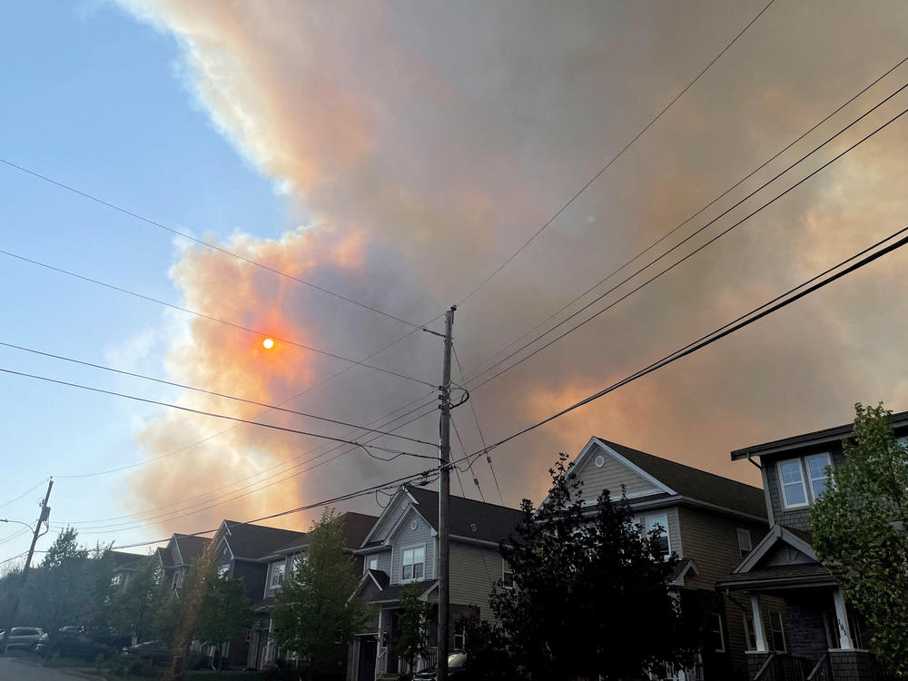 Smoke from the Tantallon wildfire rises over houses in nearby Bedford, Nova Scotia, Canada, on Sunday.