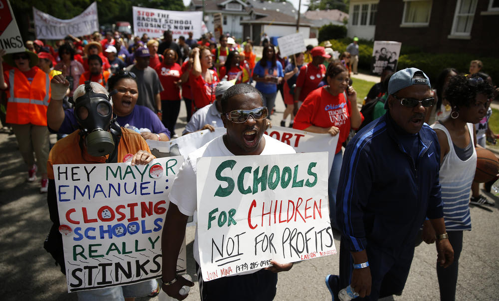 <strong>May 18, 2013:</strong> There was fierce opposition to the school closings in many quarters of the city. Matthew Johnson (center), a member of the Local School Council at Dewey Elementary Academy of Fine Arts, and others march in protest.