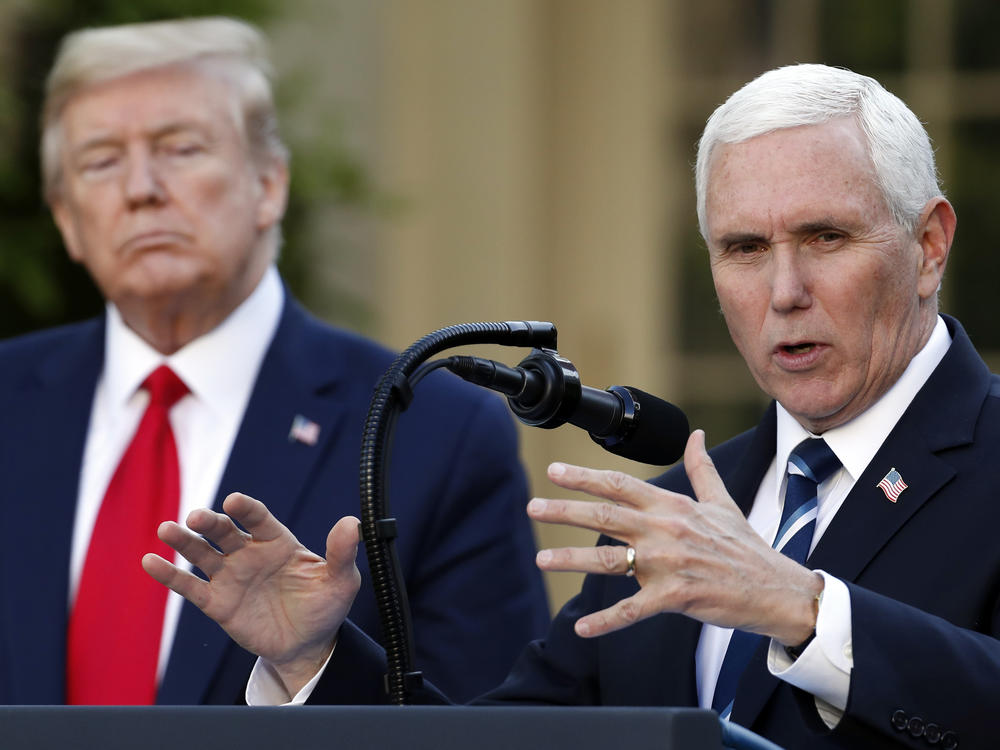 President Donald Trump listens as Vice President Mike Pence speaks about the coronavirus in the Rose Garden of the White House on April 27, 2020.
