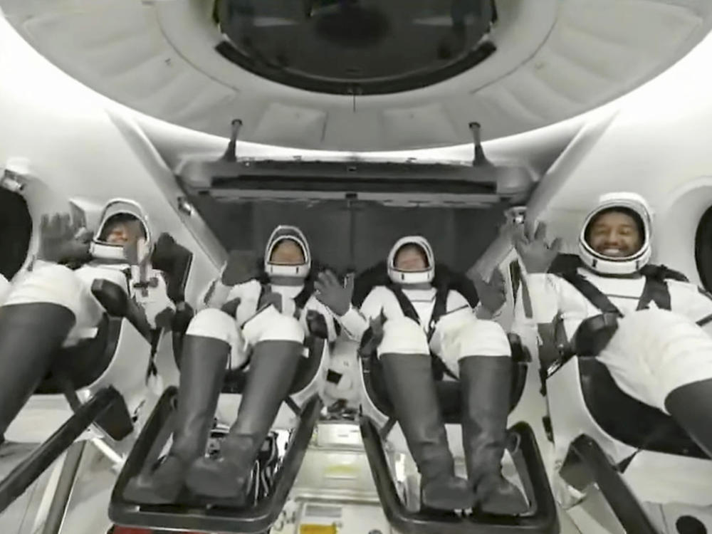 In this image taken from video broadcast by SpaceX, crew members wave after the SpaceX Dragon capsule splashed down into the Gulf of Mexico, just off the Florida Panhandle, late Tuesday, May 30, 2023.