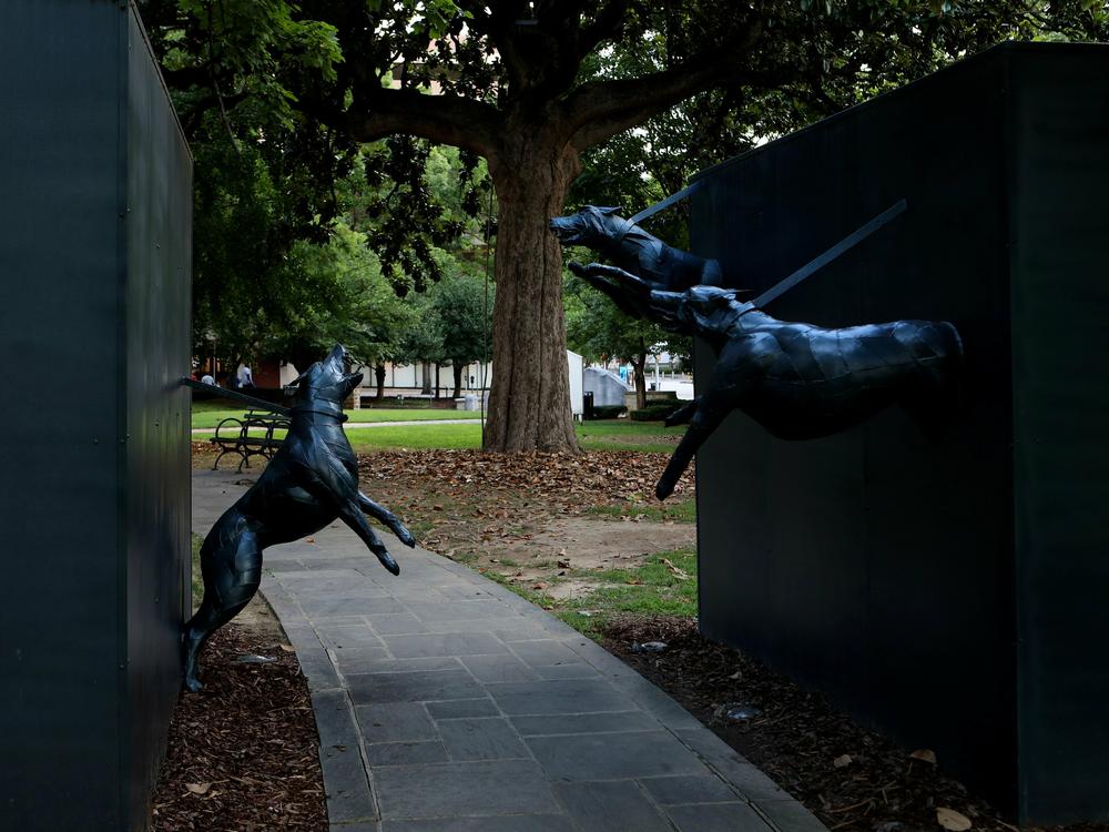 James Drake's 'Police Dog Attack' sculpture stands in Kelly Ingram Civil Rights Memorial Park in Birmingham, Ala. on July 5, 2018.
