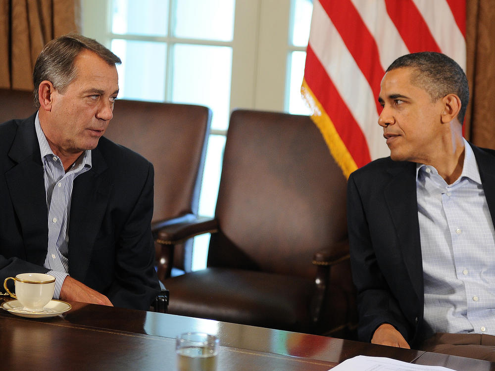 Former President Obama speaks with then House Speaker John Boehner during a meeting in the Cabinet Room at the White House in Washington, D.C., on July 23, 2011. Obama and Boehner engaged in debt ceiling brinkmanship in 2011 before both eventually reached a deal.