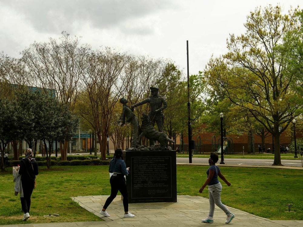 People look at a sculpture marking the Children's Crusade, across from the 16th Street Baptist Church, a Civil Rights historical site at Kelly Ingram Park on March 27, 2021 in Birmingham, Ala.