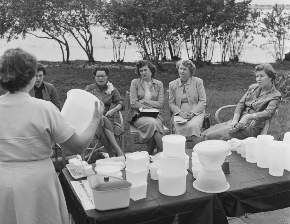 Women attend a Tupperware Party in someone's back garden in 1955.