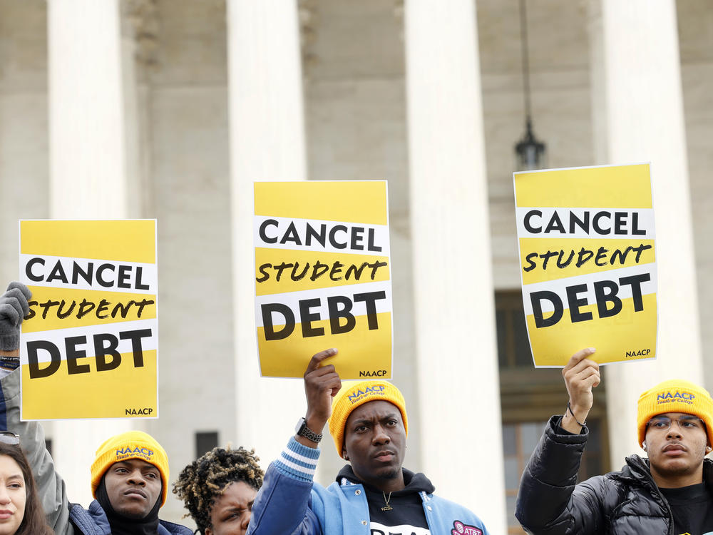 Student loan borrowers gather outside the Supreme Court building in February 2023. The court's ruling on President Biden's debt relief plan is expected in June or July.