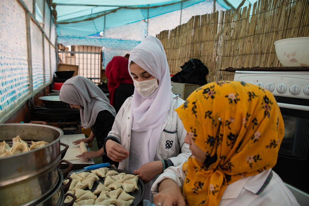 Cooks prepare a dish called samboose, a stuffed pastry, in the kitchen of the Banowan-e-Afghan restaurant.