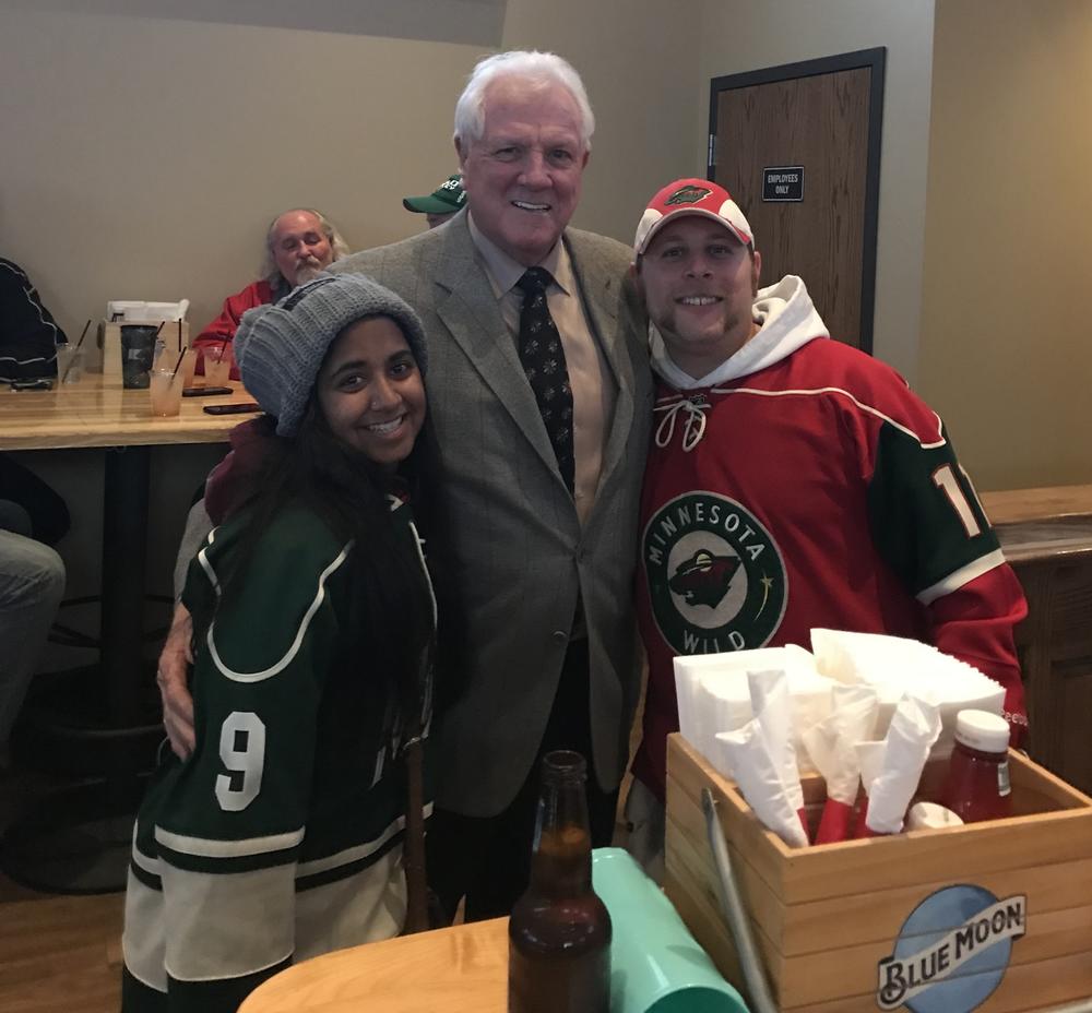 Analise with their brother and Tom Reid, a former hockey player.