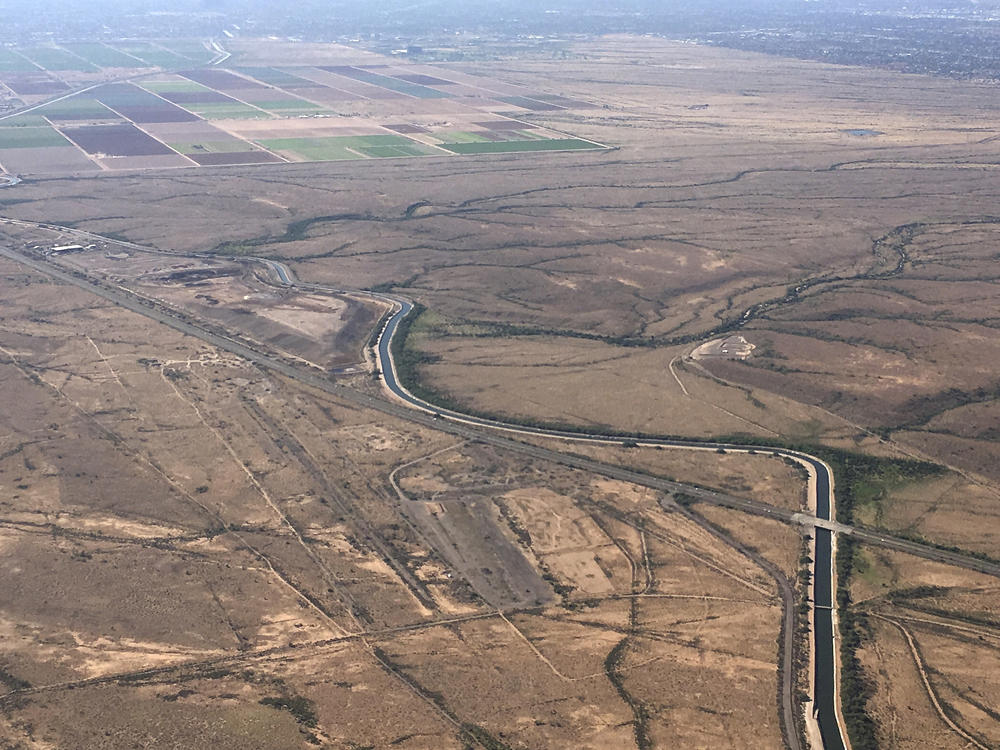 In this Oct. 8, 2019, file photo, the Central Arizona Project canal runs through rural desert near Phoenix. The canal diverts Colorado River water down a 336-mile long system of aqueducts, tunnels, pumping plants and pipelines to the state of Arizona.
