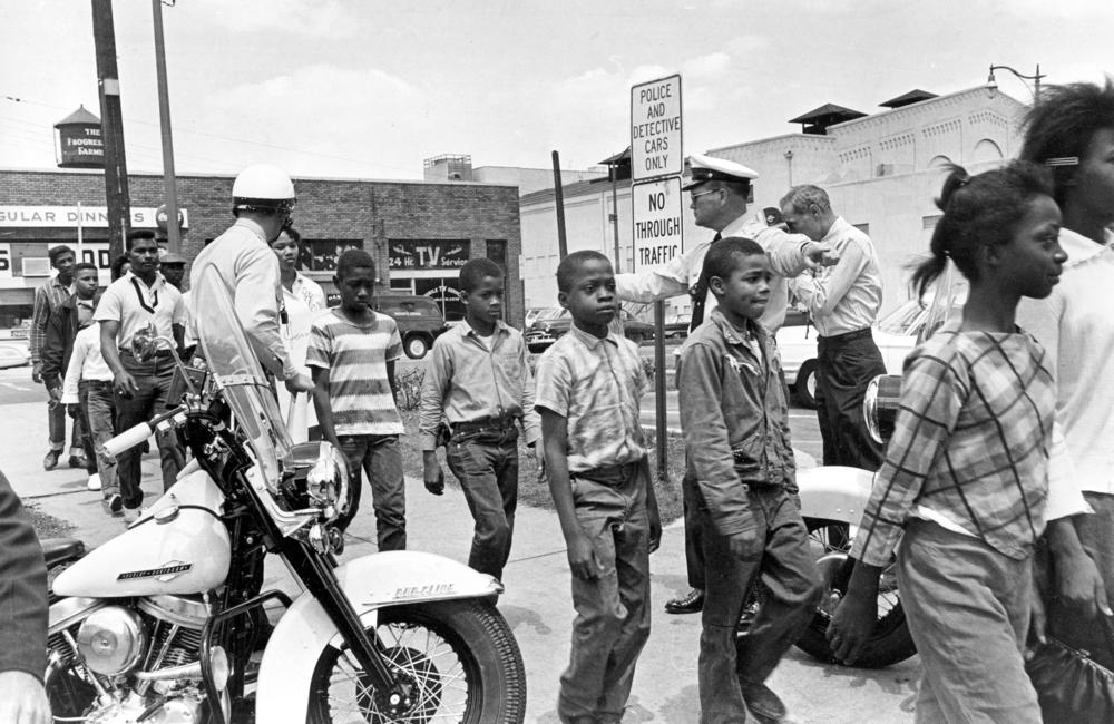 Policemen lead a group of school children into jail, following their arrest for protesting against racial discrimination near city hall of Birmingham, Ala., on May 4, 1963.