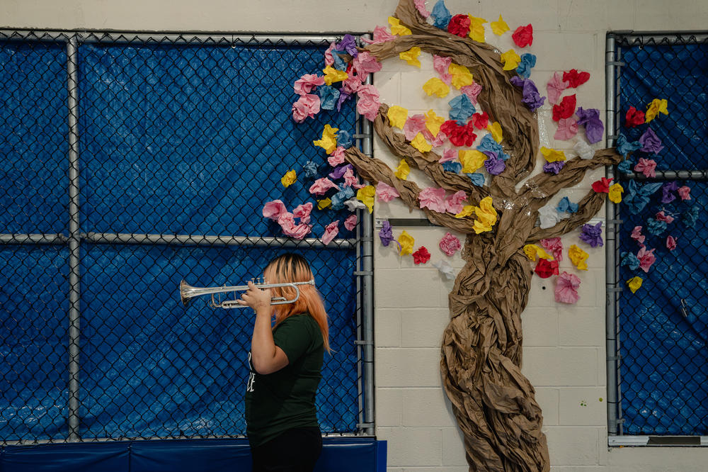 A Northern Virginia Juvenile Detention Center resident holds a trumpet after her final performance of the residency.